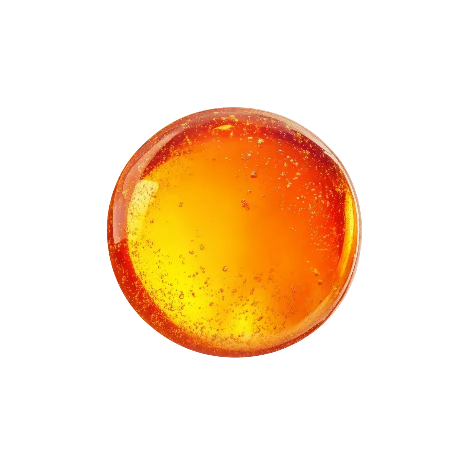 Orange astaxanthin extract with a rich golden colour and visible bubbles, used as a skincare ingredient.