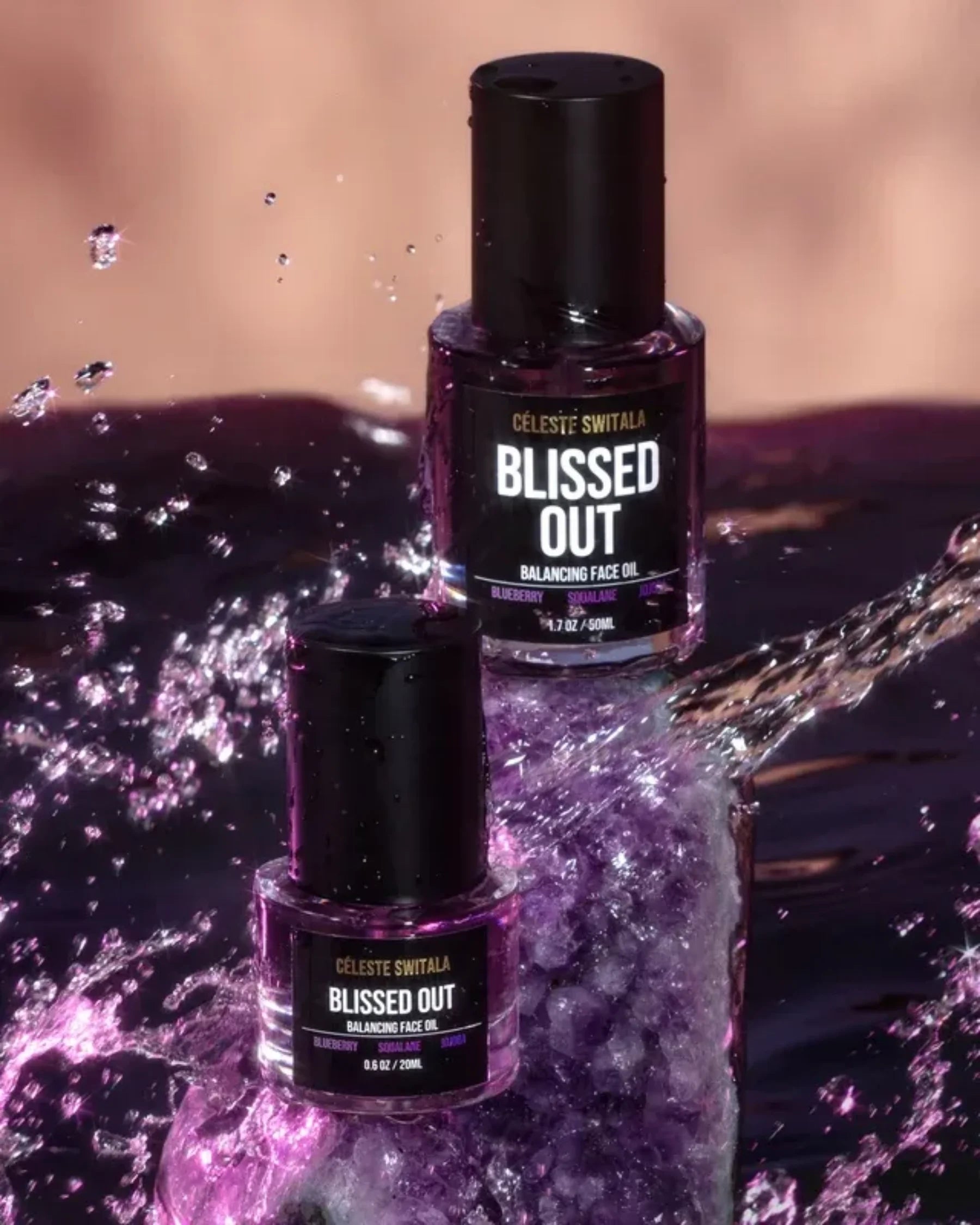 Blissed Out Balancing Face Oil 50 ml and 20 ml bottles in purple water display