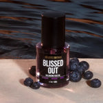 Blissed Out Balancing Face Oil displayed with fresh blueberries