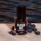 Blissed Out Balancing Face Oil displayed with fresh blueberries