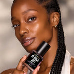 Model holding Blissed Out Balancing Face Oil by Céleste Switala