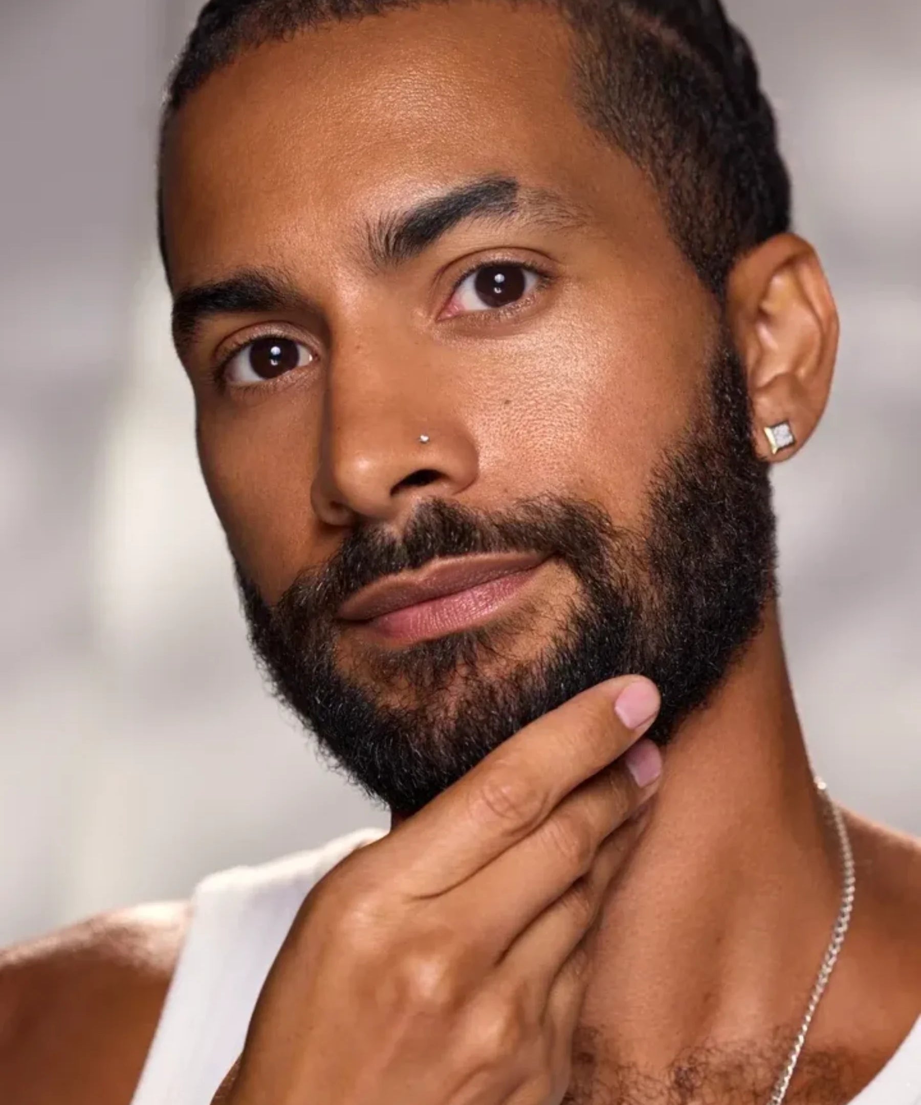 Model with a groomed beard demonstrating men's beard and facial care