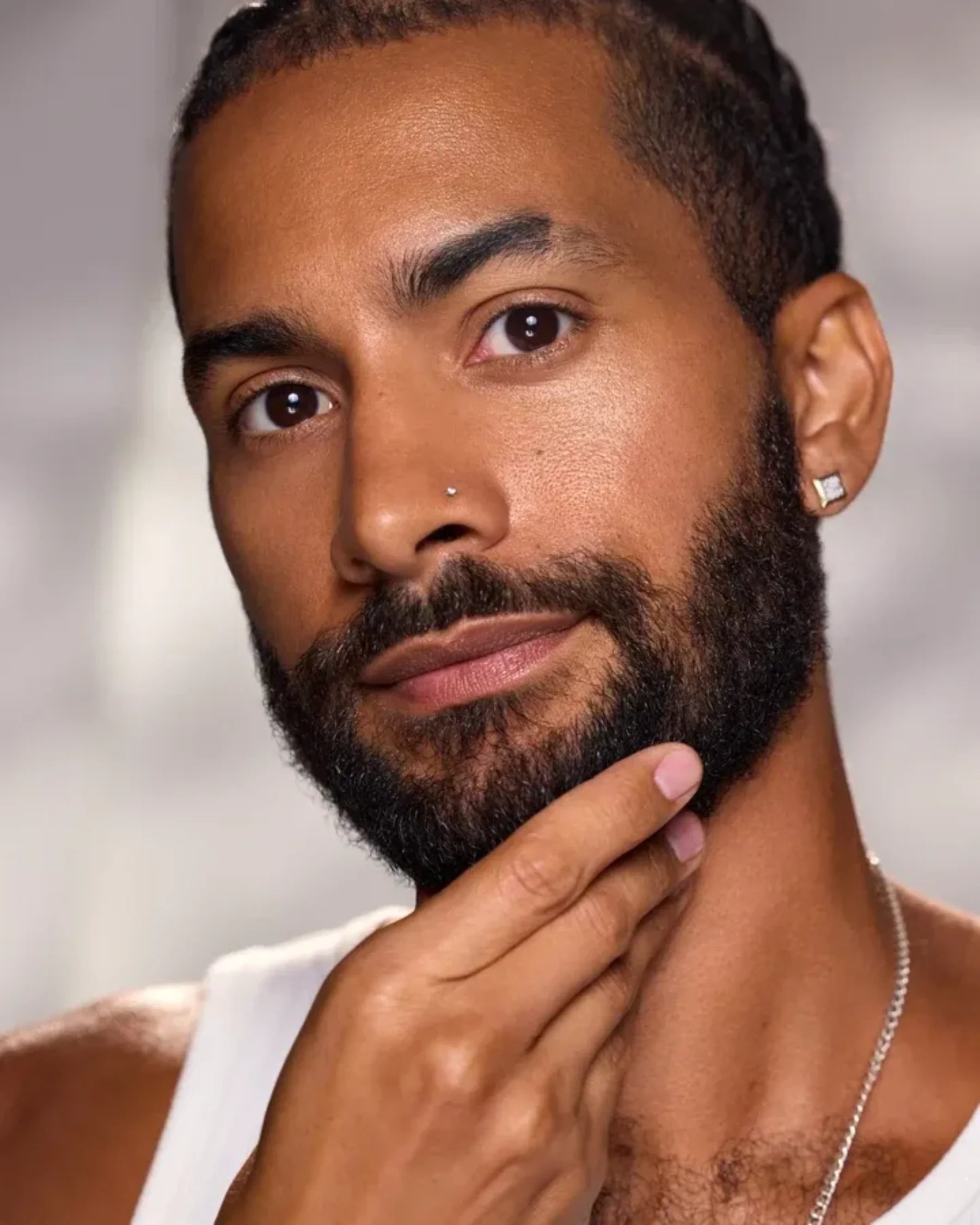 Model with a groomed beard demonstrating men's beard and facial care