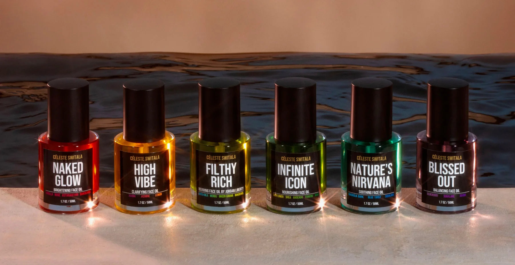 Six Céleste Switala face oil bottles featuring Naked Glow, High Vibe, Filthy Rich, Infinite Icon, Nature’s Nirvana, and Blissed Out, displayed against a dark water background.