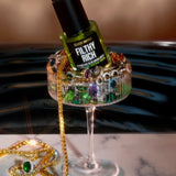 Filthy Rich Reviving Face Oil displayed with colorful luxury jewelry