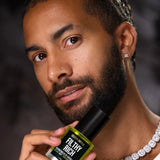 Man holding Céleste Switala Filthy Rich Reviving Face Oil beside his face