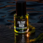 Filthy Rich Reviving Face Oil displayed with green caviar botanical ingredients
