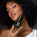 Model holding Filthy Rich Reviving Face Oil by Céleste Switala