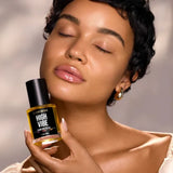 Model holding High Vibe Clarifying Face Oil by Céleste Switala