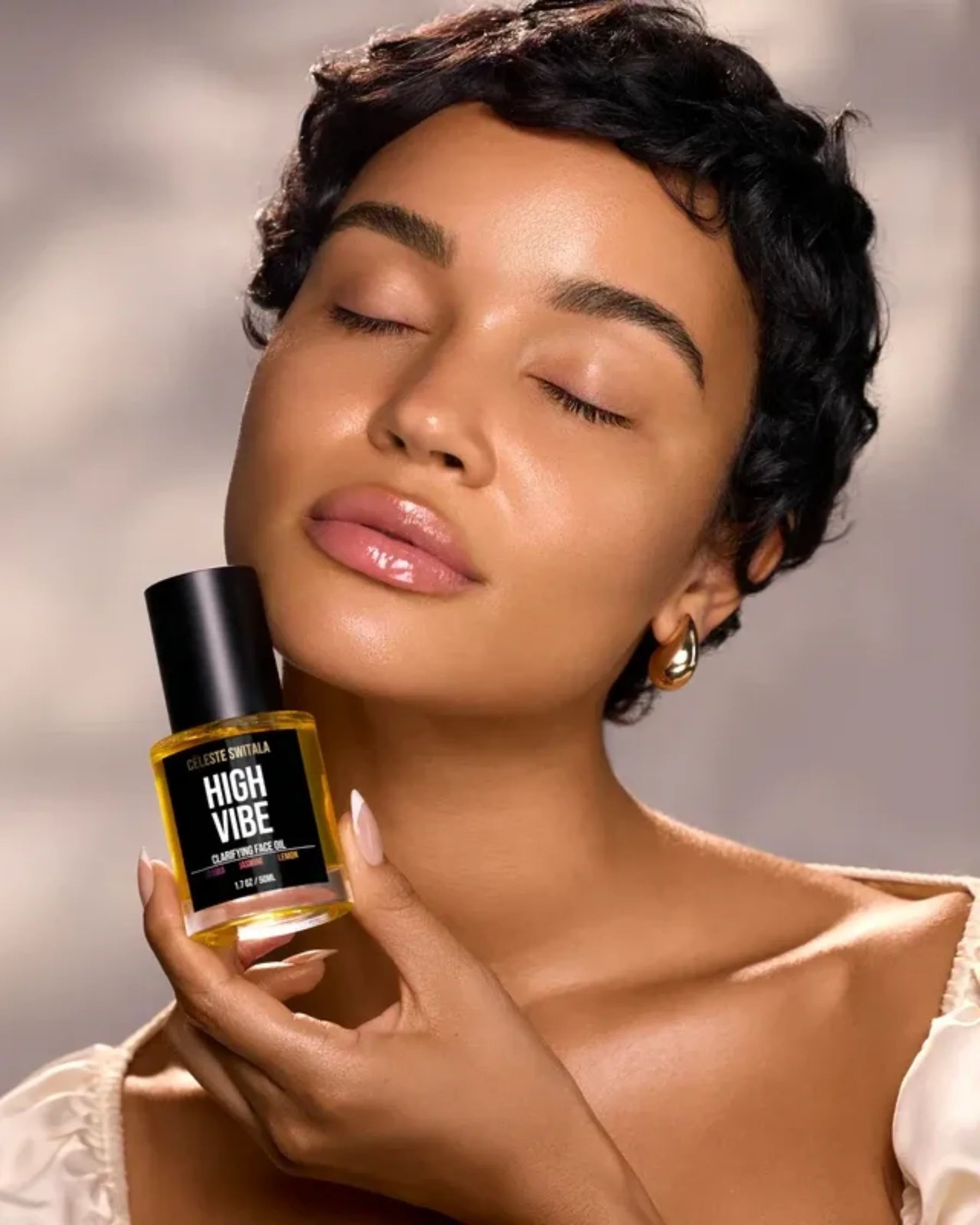 Model holding High Vibe Clarifying Face Oil by Céleste Switala