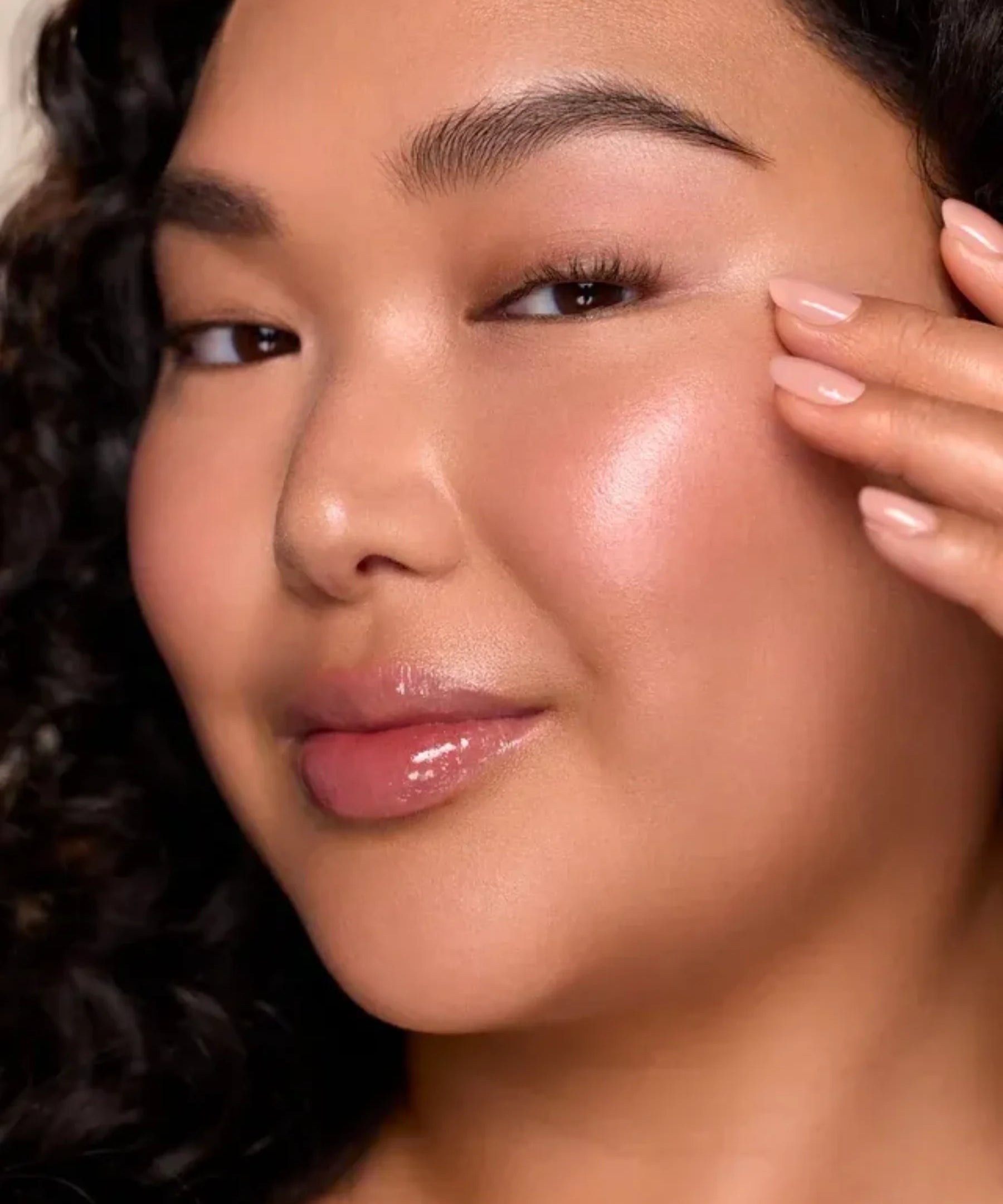 Woman with luminous glowing skin showcasing Infinite Icon Nourishing Face Oil skincare results