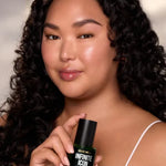 Model holding Infinite Icon Nourishing Face Oil by Céleste Switala