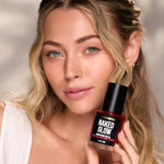 Model holding Naked Glow Brightening Face Oil by Céleste Switala