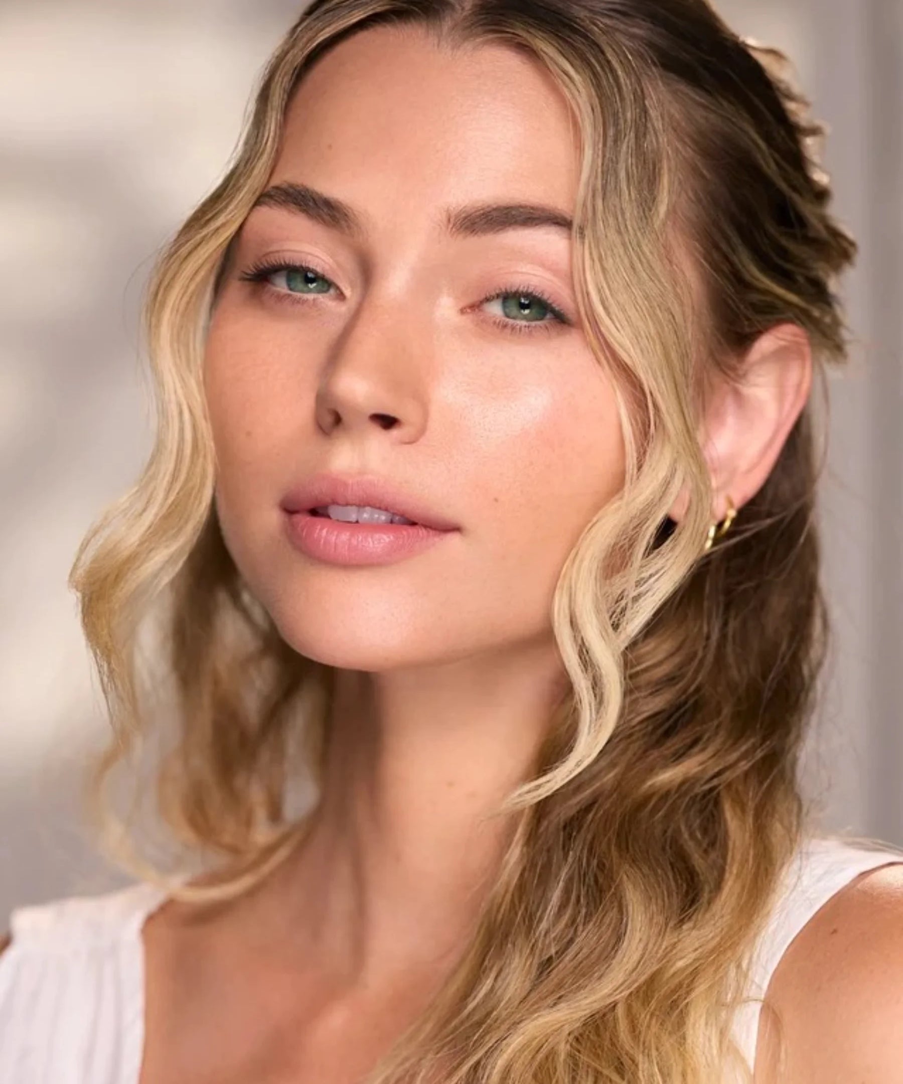 Woman with radiant skin in the Céleste Switala Naked Glow skincare campaign