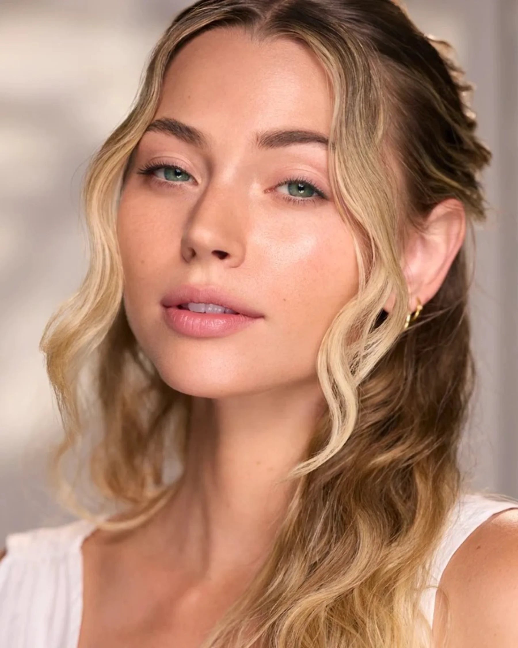 Woman with radiant skin in the Céleste Switala Naked Glow skincare campaign