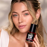 Woman holding Céleste Switala Naked Glow Brightening Face Oil beside her face