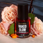 Naked Glow Brightening Face Oil displayed with roses and vanilla