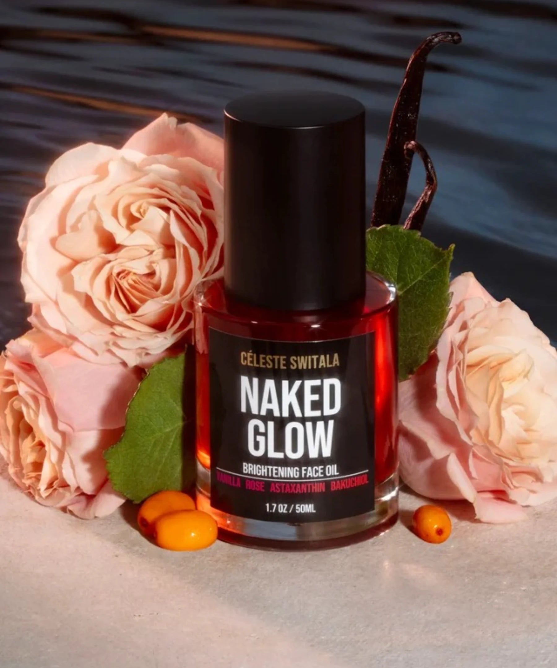Naked Glow Brightening Face Oil displayed with roses and vanilla